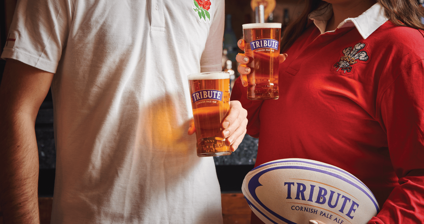 Two rugby fans watching the Rugby Six Nations in pub.